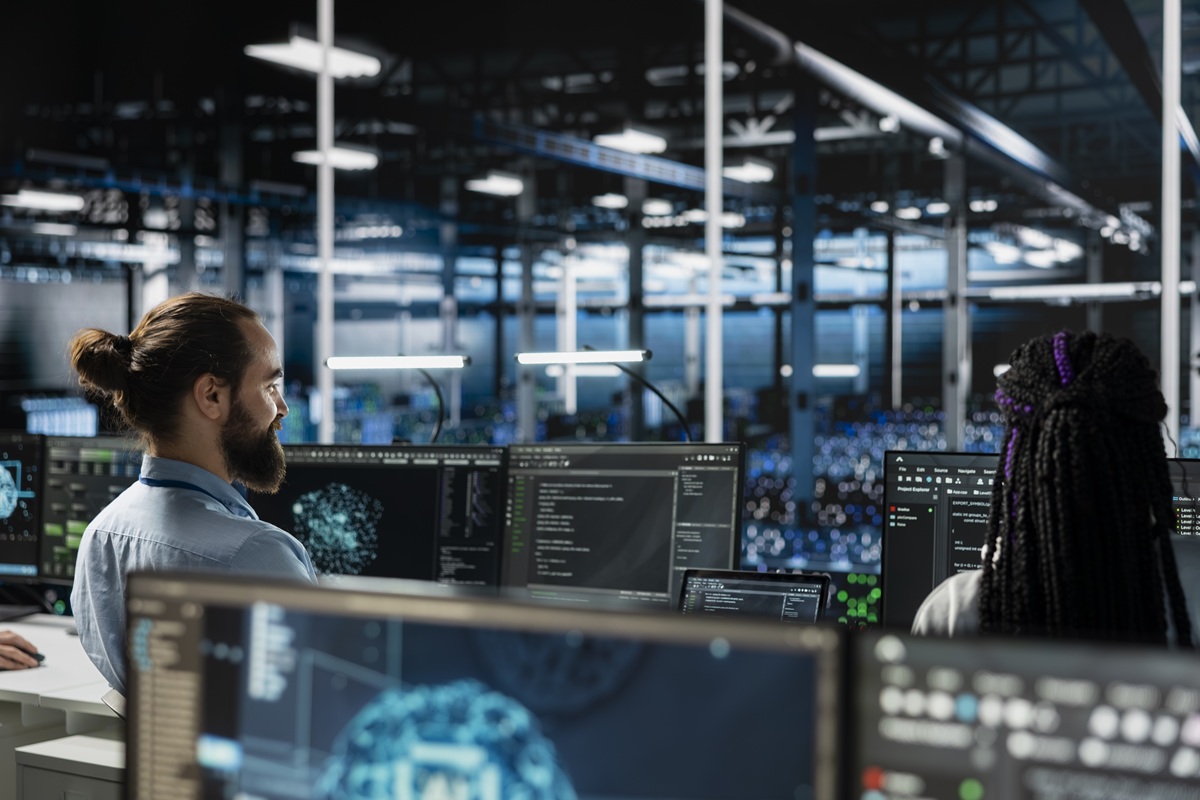 Data center computer scientist working on databases supporting AI applications. IT worker in server room conducting experiments on artificial intelligence algorithms improvements
